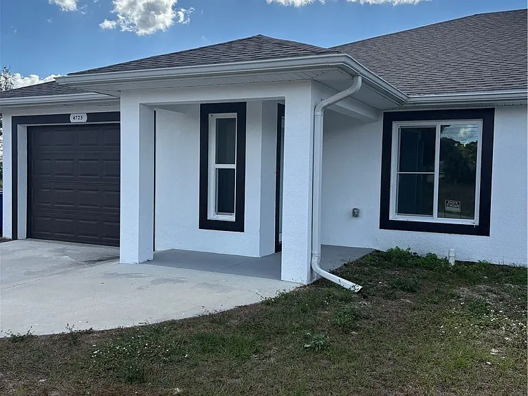Front exterior of 4725 21st St SW with the attached garage and covered entry